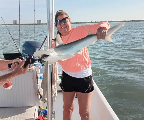 woman holding a shark, fort myers fishing charters, fort myers beach shark fishing charters, luck o' the irish fishing charters, snapper, shark