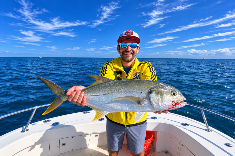 a man holding a nice sized jack on a nearshore charter with luck o' the irish fishing charters