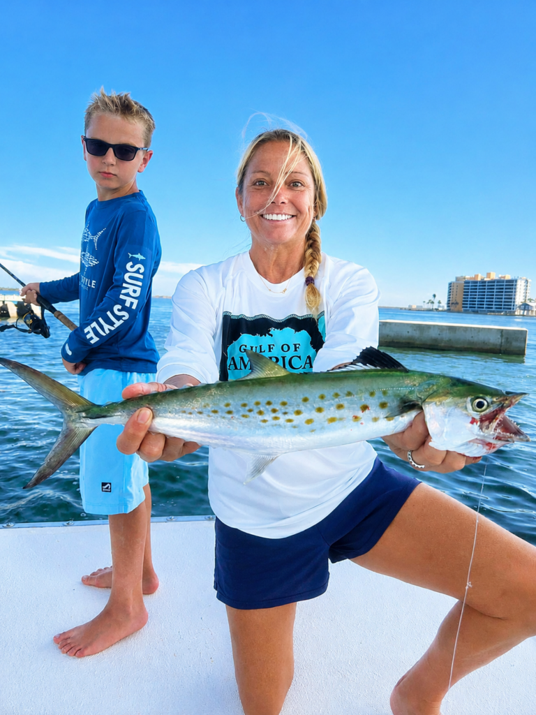 a mom and her son fishing with luck o' the irish fishing charters holding a spotted seatrout
